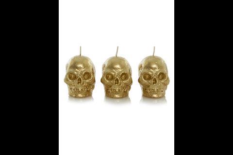 Asda is selling Halloween-themed decorative items such as skull-shaped candles and glitter pumpkin decorations.